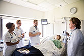 Nursing students with professor in simulation lab