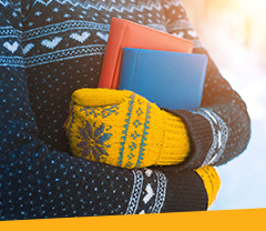 Image of Student holding books in the winter