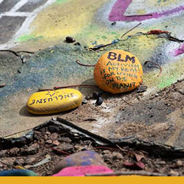Image of rock painted with activist messages 