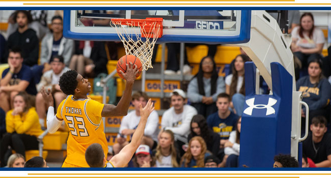 Image of KSU Golden Flash Dunking a basketball